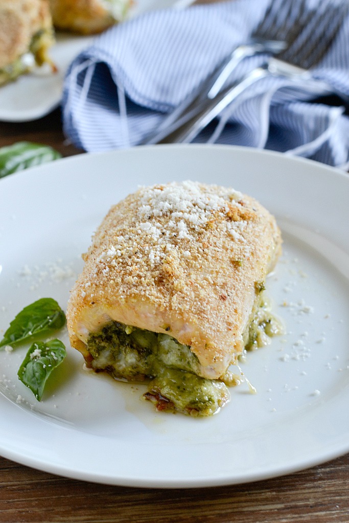 An easy recipe for Pesto Chicken Roll-Ups filled with fresh basil pesto and shredded mozzarella cheese then rolled up and coated with breadcrumbs for a delicious meal that is simple to make and yummy to eat.