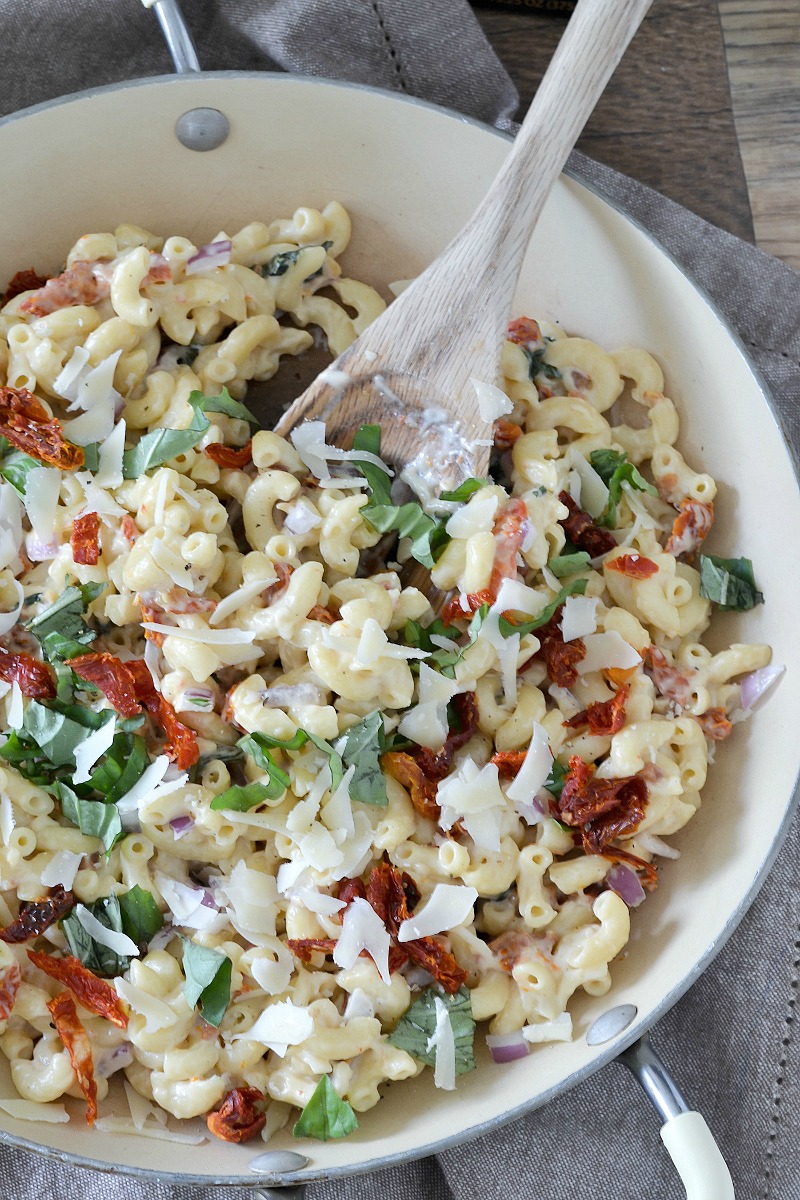 An easy family-friendly recipes for macaroni tossed in a lightened up garlic cream sauce with sun-dried tomatoes and basil. A delicious meatless meal ready in about 30 minutes! #HealthyPastaMonth