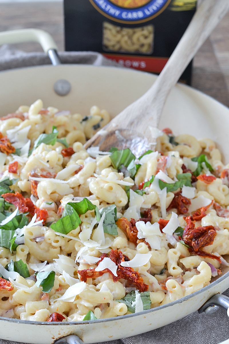 An easy family-friendly recipes for macaroni tossed in a lightened up garlic cream sauce with sun-dried tomatoes and basil. A delicious meatless meal ready in about 30 minutes! #HealthyPastaMonth