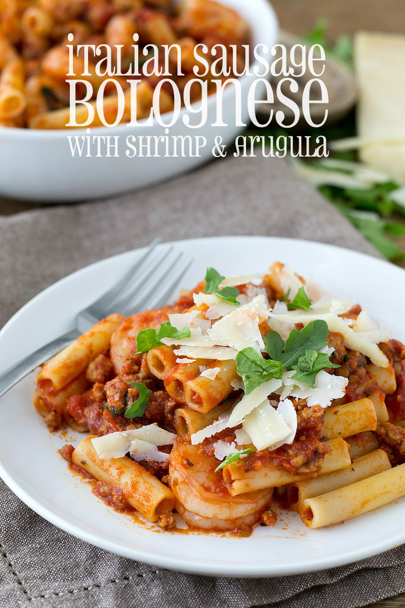 Gather the family around the table for this delicious Italian Sausage Bolognese tossed with pasta, shrimp and arugula ready in about 30 minutes!