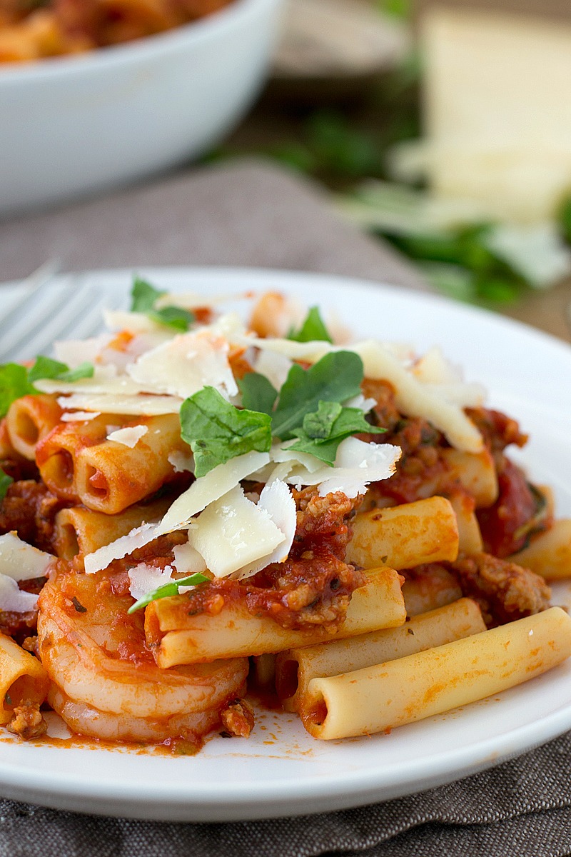 Gather the family around the table for this delicious Italian Sausage Bolognese tossed with pasta, shrimp and arugula ready in about 30 minutes!