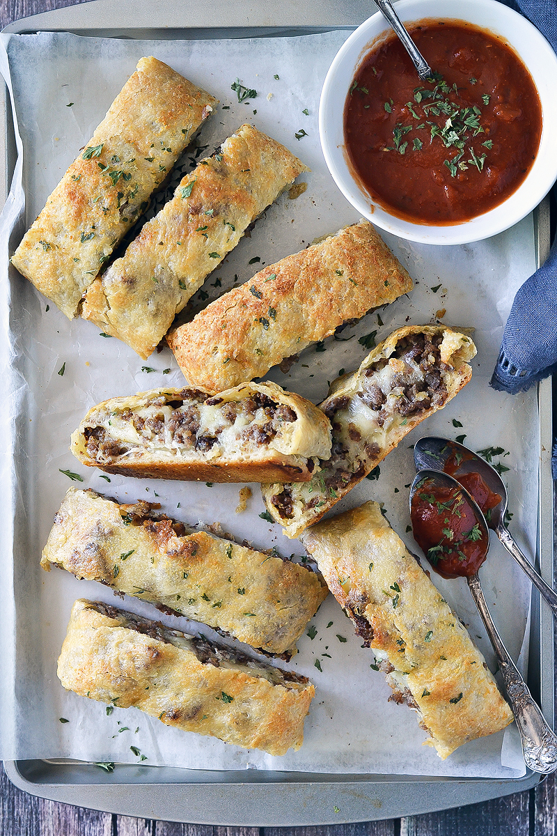 Wow! There is SO MUCH goodness going on in this Cheesy Sausage Bread! Have you ever had sausage bread before? If not, you're in for a real treat. If you have, then I bet you're craving some right now! <img class="aligncenter size-full wp-image-13481" src="https://www.motherthyme.com/wp-content/uploads/2018/06/CHEESY-SAUSAGE-BREAD.jpg" alt="CHEESY SAUSAGE BREAD" width="800" height="1200" /> <img class="aligncenter size-full wp-image-13477" src="https://www.motherthyme.com/wp-content/uploads/2018/06/CHEESY-SAUSAGE-BREAD-2A.jpg" alt="CHEESY SAUSAGE BREAD" width="800" height="1200" /> Sausage bread is obviously bread with sausage in it. There are a variety of sausage breads, some are actually breads with sausage in it, others will be chunks of chopped sausage links. If you searched sausage bread you're bound to find a ton of varieties. This my friends is my version and I must say it's the pretty amazing! Not only is this Cheesy Sausage Bread loaded with yumminess, it's super easy to make! With a pound of breakfast sausage roll, a tube of prepared pizza dough, a little cream cheese, shredded cheese, butter and some spices you can whip up this Cheesy Sausage Roll in no time. <img class="aligncenter size-full wp-image-13479" src="https://www.motherthyme.com/wp-content/uploads/2018/06/CHEESY-SAUSAGE-BREAD-3.jpg" alt="CHEESY SAUSAGE BREAD" width="800" height="1200" /> This makes a perfect party app (think ahead to football season), a summer picnic, or even as a meal. No matter how you serve it, everyone will sure love it! The best way to serve this is warm, not hot. I like to let it sit for a good 15-20 minutes after I bake it before I slice it up. Even if it gets cool it's still really good which is why it makes a great party app or to even take to a picnic. While this sausage bread is mighty tasty just on its own, serving it with some warm marinara for dipping on the side takes it to another level. Seriously once you try this you'll see why. <img class="aligncenter size-full wp-image-13476" src="https://www.motherthyme.com/wp-content/uploads/2018/06/CHEESY-SAUSAGE-BREAD-6A.jpg" alt="CHEESY SAUSAGE BREAD" width="800" height="1200" />
